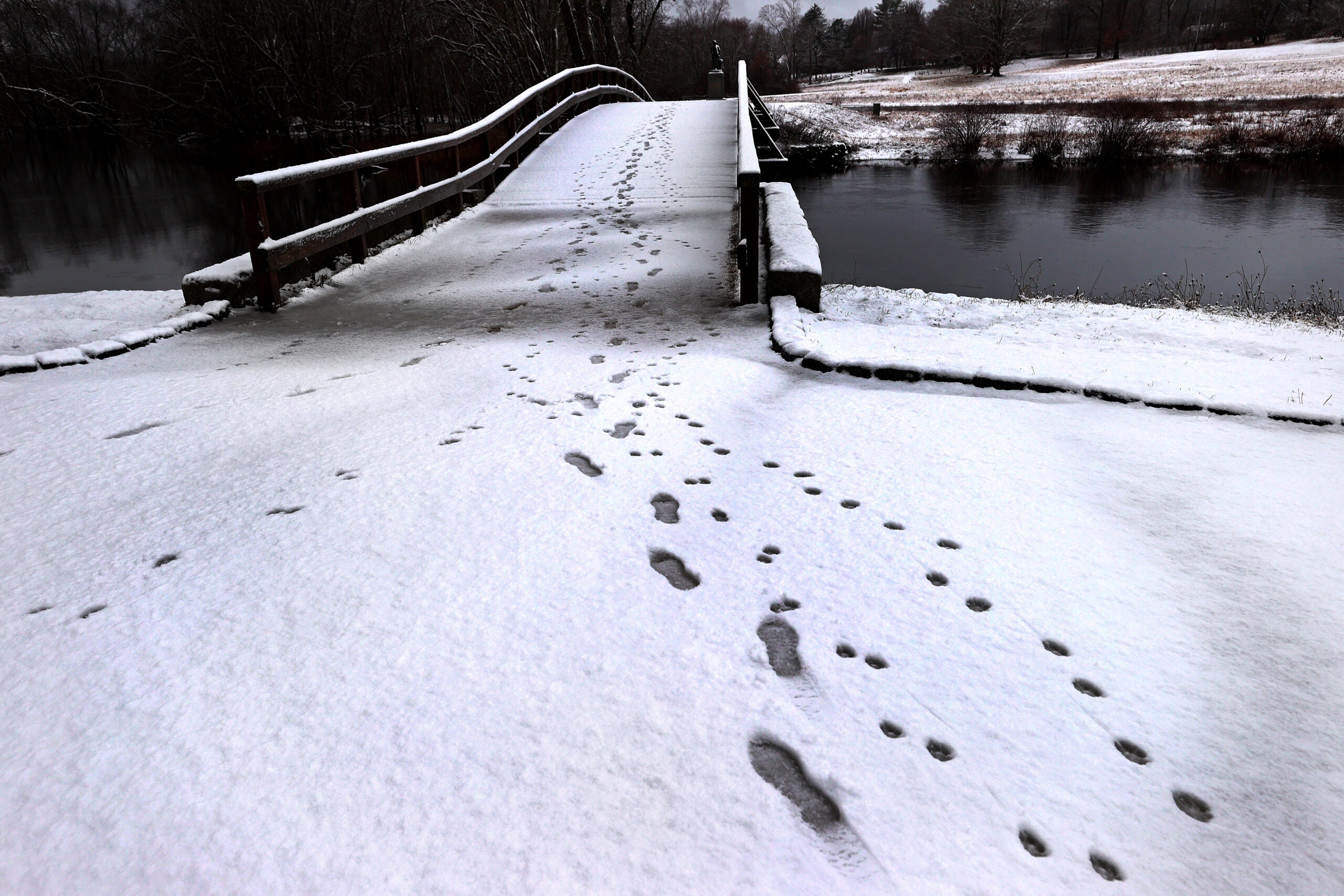 Footprints in the snow by Concord's North Bridge on Friday morning.