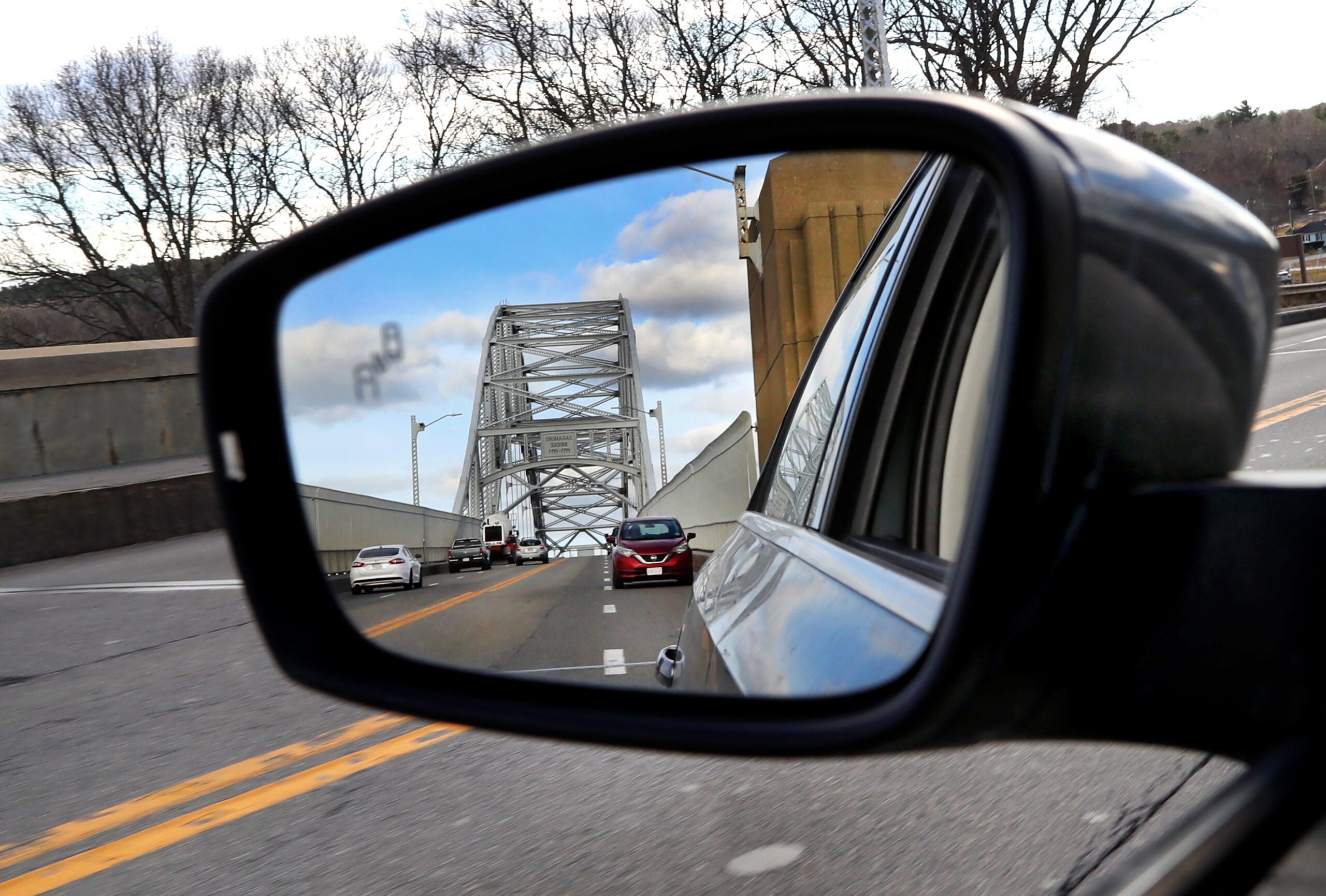 The Sagamore Bridge is seen in the rearview mirror. 
