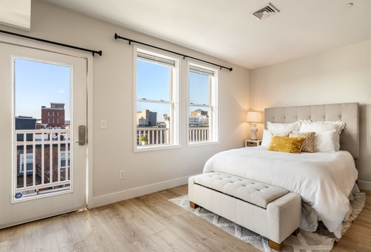 The bedroom nook has single-hung windows and a door to the deck.