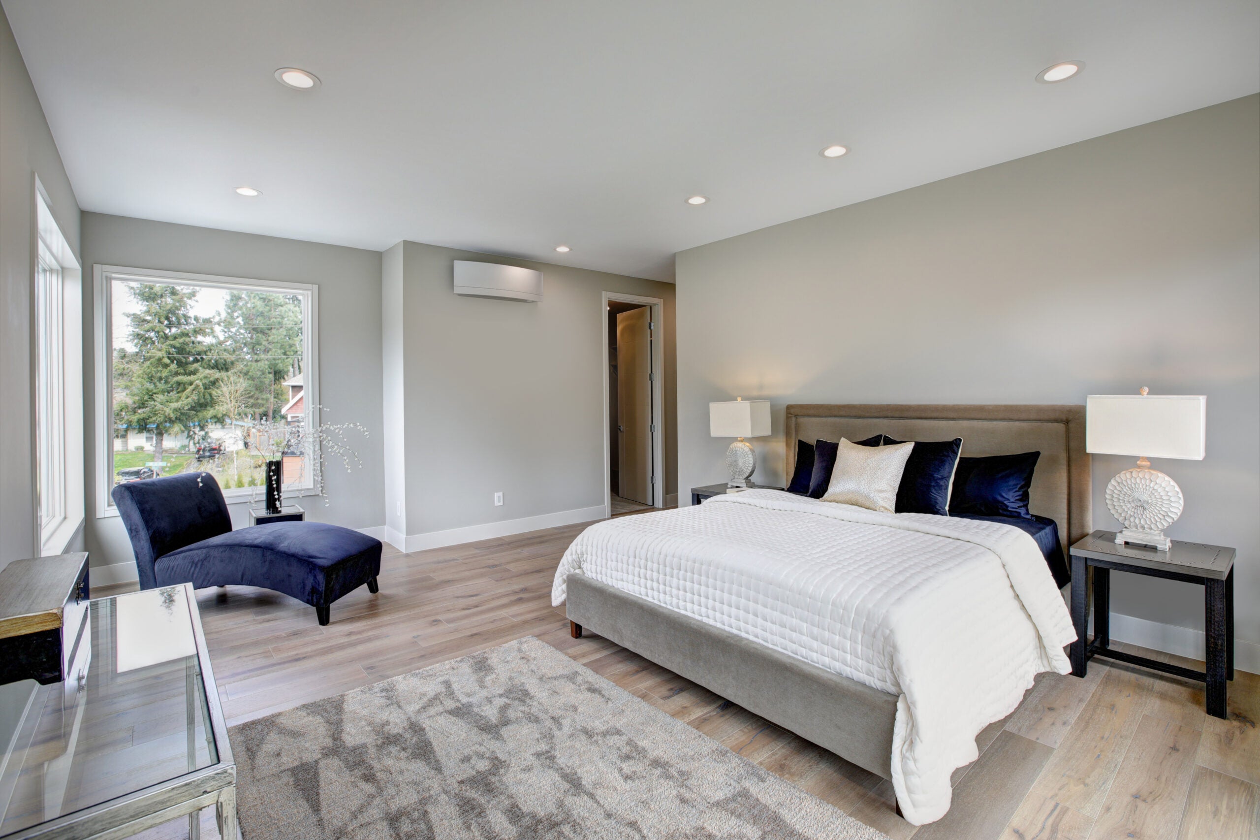 Master bedroom interior with private balcony in a new construction home. Northwest, USA