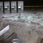 The empty Alewife lobby is shown with broken glass blanketing the ground following the crash.