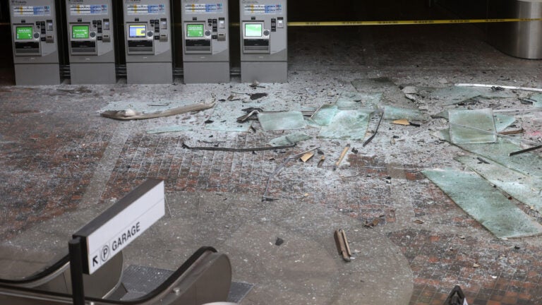 The empty Alewife lobby is shown with broken glass blanketing the ground following the crash.