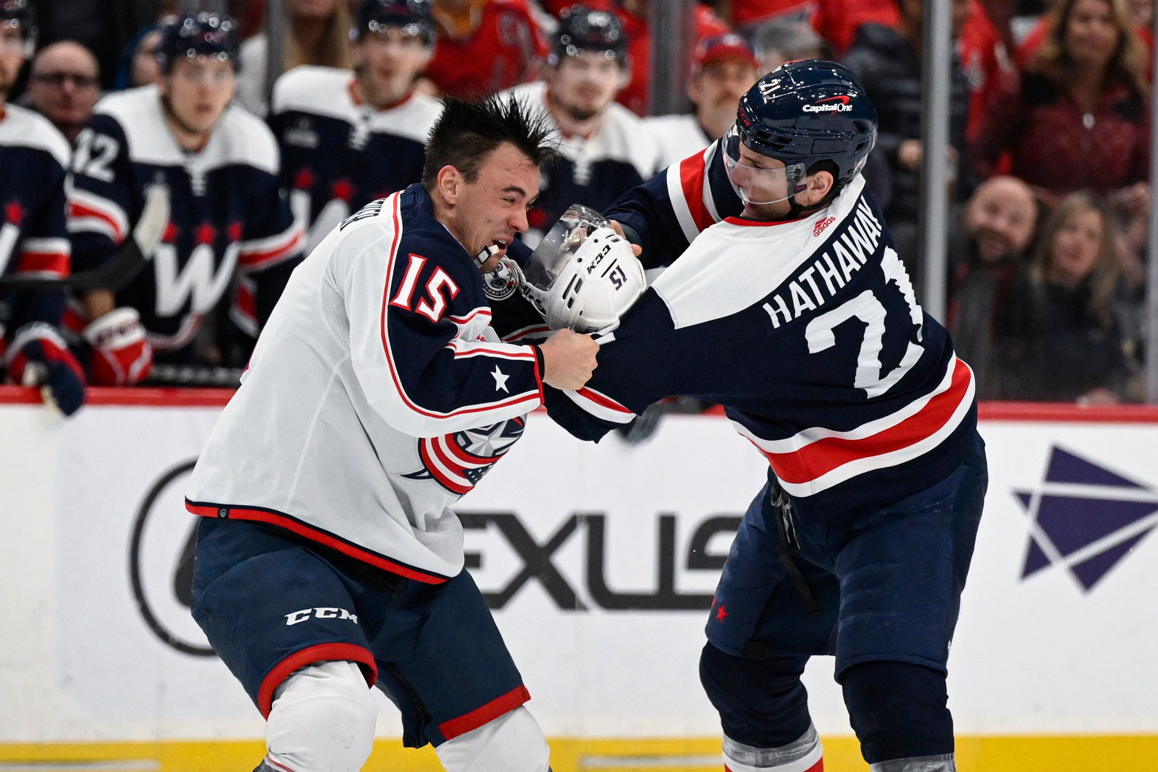 Columbus Blue Jackets defenseman Gavin Bayreuther (15) and Washington Capitals right wing Garnet Hathaway (21) fight during the first period of an NHL hockey game, Sunday, Jan. 8, 2023, in Washington.