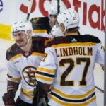 Boston Bruins defenseman Dmitry Orlov, left, celebrates his goal against the Calgary Flames with teammates during the first period of an NHL hockey game Tuesday, Feb. 28, 2023, in Calgary, Alberta.