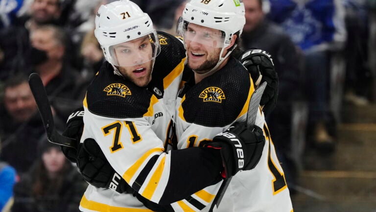 Boston Bruins' Pavel Zacha, right, celebrates scoring a goal against the Toronto Maple Leafs with teammate Taylor Hall during the third period.