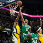 Jayson Tatum shoots against Pacers center Myles Turner during the first half.