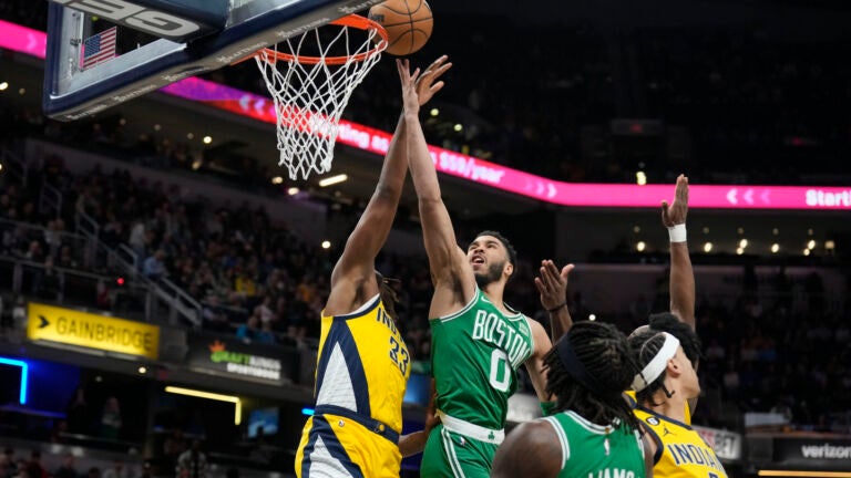 Jayson Tatum shoots against Pacers center Myles Turner during the first half.