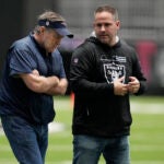 New England Patriots head coach Bill Belichick, left, speaks with Las Vegas Raiders head coach Josh McDaniels during a West football practice for the East West Shrine Bowl, Tuesday, Jan. 31, 2023, in Henderson, Nev.