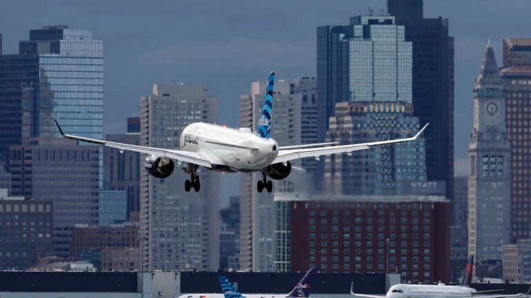 A JetBlue plane lands at Logan Airport, Thursday, Jan. 26, 2023.