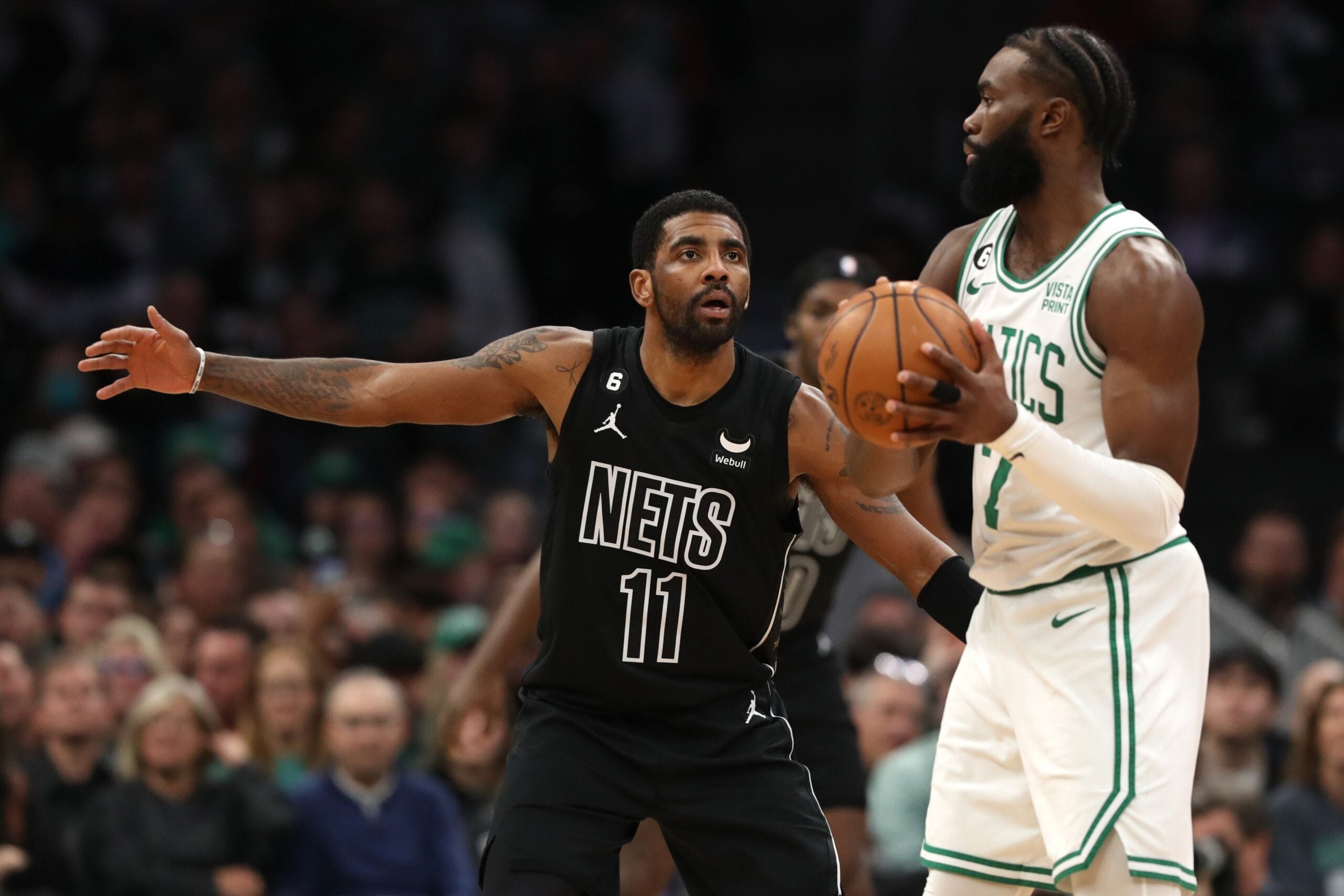 Kyrie Irving #11 of the Brooklyn Nets defends Jaylen Brown #7 of the Boston Celtics during the first half at TD Garden on February 01, 2023 in Boston, Massachusetts.