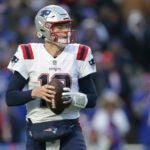 New England Patriots quarterback Mac Jones (10) looks to pass during the second half of an NFL football game against the Buffalo Bills on Sunday, Jan. 8, 2023, in Orchard Park, N.Y.