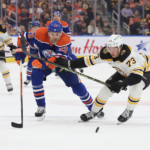 Charlie McAvoy #73 of the Boston Bruins battles for the puck with Leon Draisaitl #29 of the Edmonton Oilers in the second period on February 27, 2023 at Rogers Place in Edmonton, Alberta, Canada.