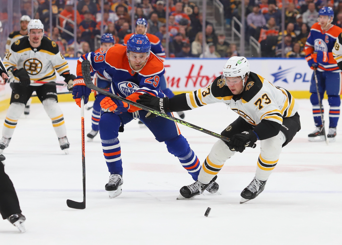 Charlie McAvoy #73 of the Boston Bruins battles for the puck with Leon Draisaitl #29 of the Edmonton Oilers in the second period on February 27, 2023 at Rogers Place in Edmonton, Alberta, Canada.