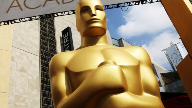 alt = a large gold Oscar statue appears outside the Dolby Theatre for the 87th Academy Awards in Los Angeles.