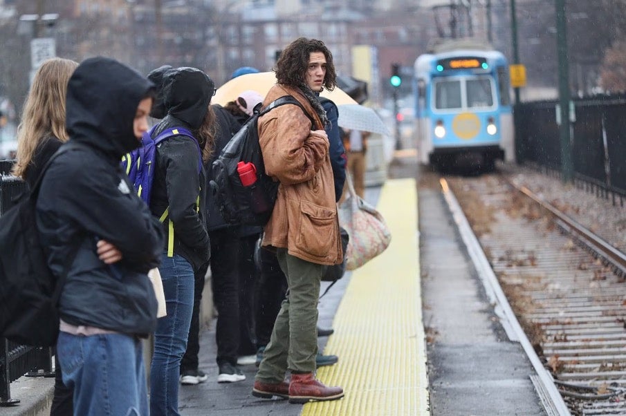 People lined up for the T on Commonwealth Avenue in Allston.