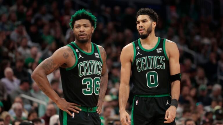 Jayson Tatum #0 of the Boston Celtics and Marcus Smart #36 of the Boston Celtics look on against the Washington Wizards during the second quarter at TD Garden on October 30, 2022 in Boston, Massachusetts.