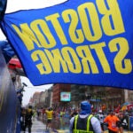 A Boston Strong flag held by Carlos Arredondo at the finish line of the 2015 Boston Marathon.
