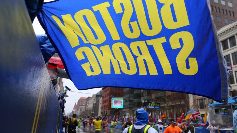A Boston Strong flag held by Carlos Arredondo at the finish line of the 2015 Boston Marathon.