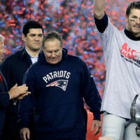 New England Patriots quarterback Tom Brady, right, holds the AFC championship trophy beside team owner Robert Kraft, left, honorary captain Tedy Bruschi, second from left, and head coach Bill Belichick after the AFC championship NFL football game, Sunday, Jan. 22, 2017, in Foxborough, Mass. The New England Patriots defeated the the Pittsburgh Steelers 36-17 to advance to the Super Bowl. 