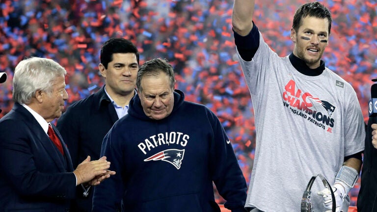 New England Patriots quarterback Tom Brady, right, holds the AFC championship trophy beside team owner Robert Kraft, left, honorary captain Tedy Bruschi, second from left, and head coach Bill Belichick after the AFC championship NFL football game, Sunday, Jan. 22, 2017, in Foxborough, Mass. The New England Patriots defeated the the Pittsburgh Steelers 36-17 to advance to the Super Bowl. 