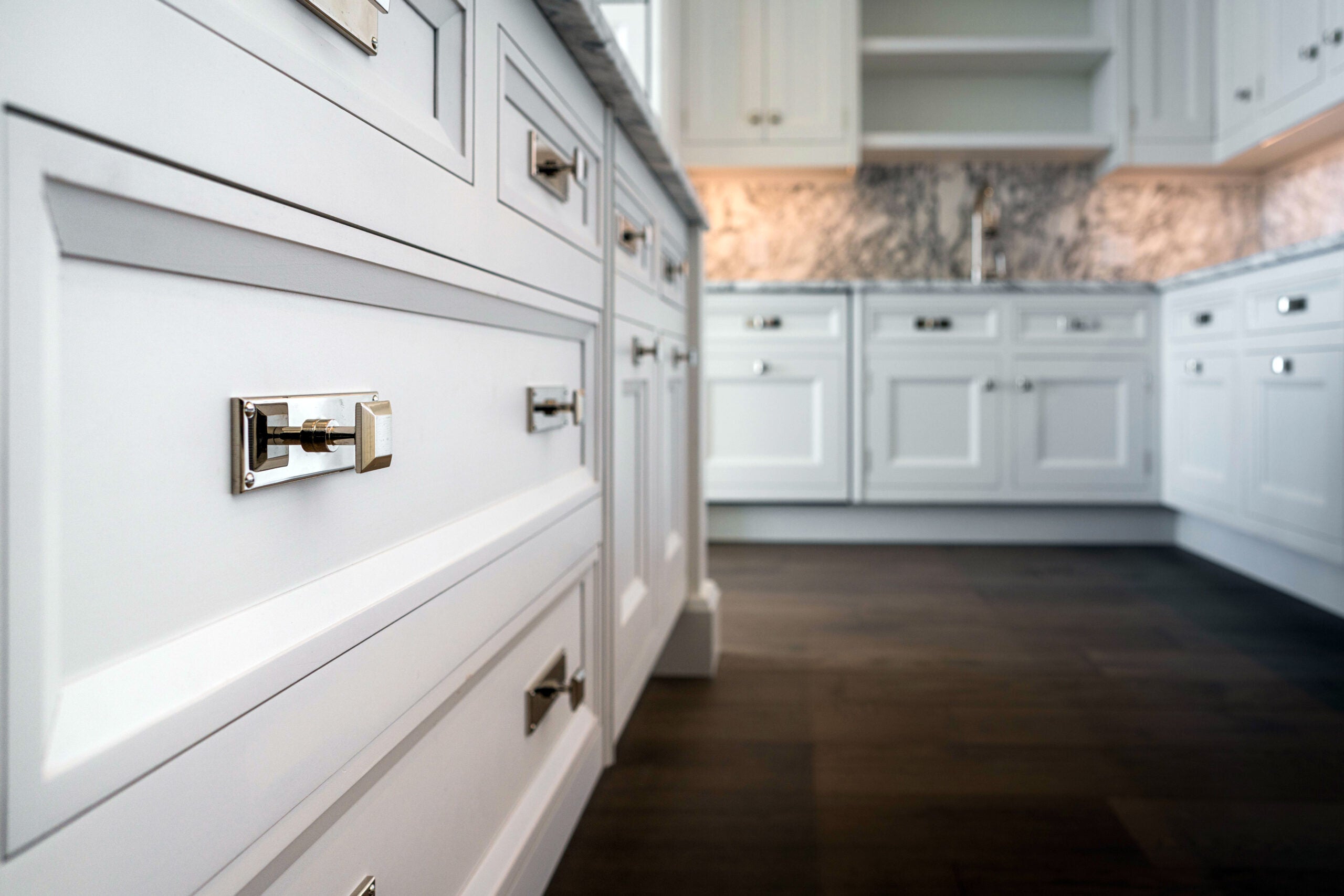 A close-up look at white kitchen drawers.