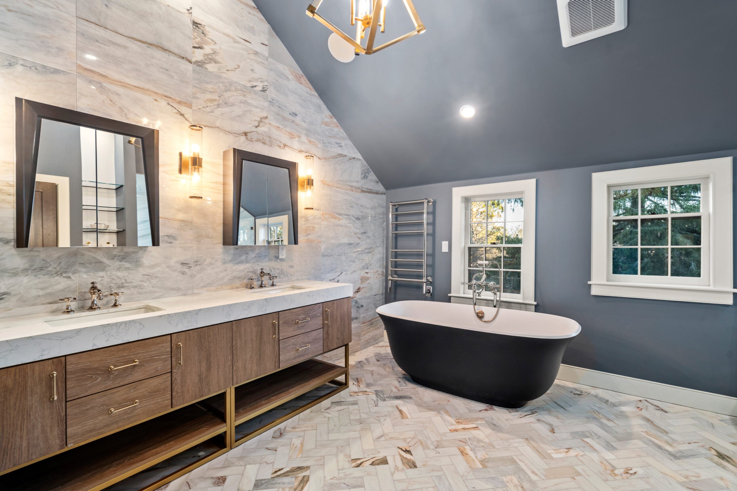 The bathroom has vaulted ceilings, a double vanity, standalone bathtub and walk-in shower.