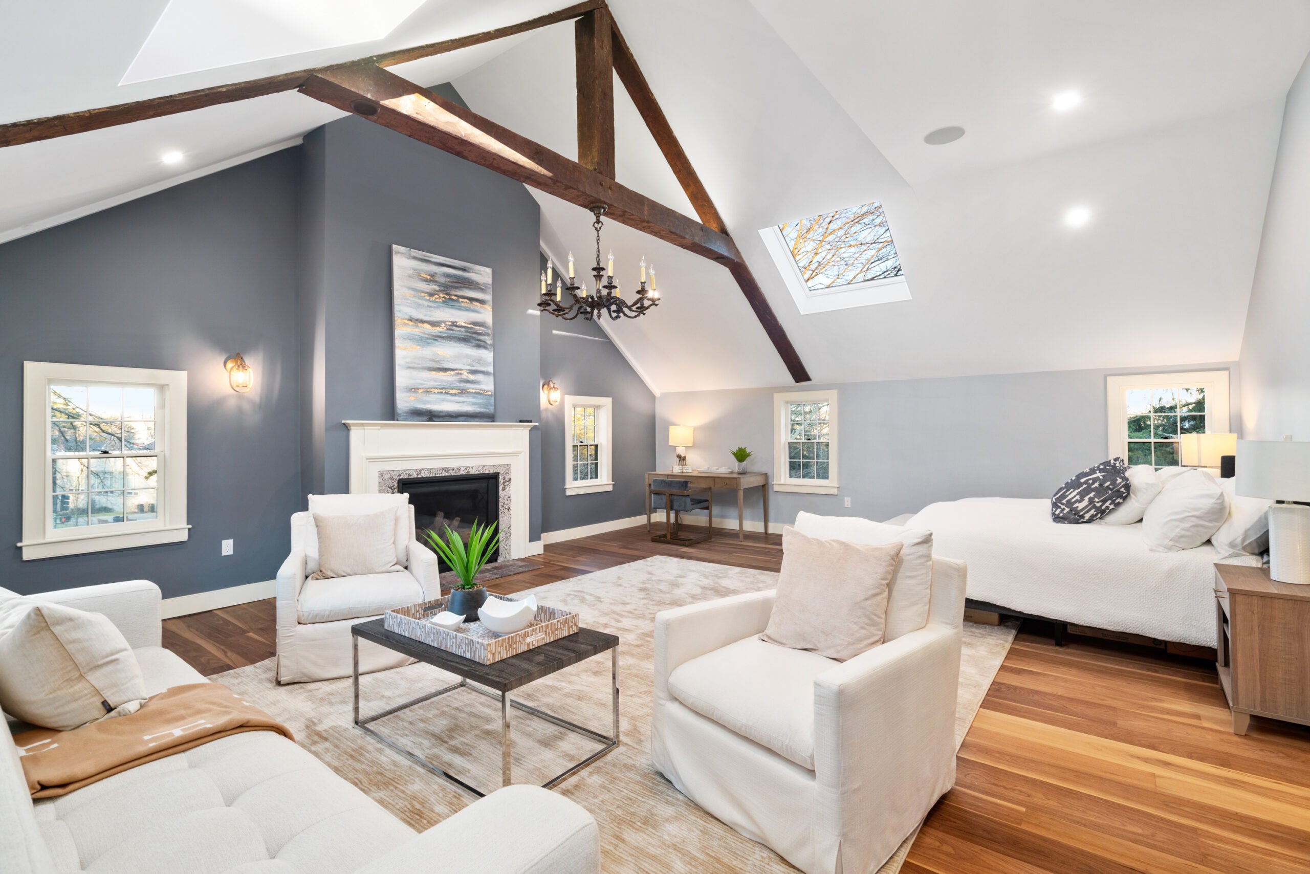 The living room has a vaulted ceiling, hardwood floors, and a fireplace.