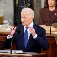 alt = President Biden in a suit with a blue tie talks with his hands as he delivers his State of the Union address to a joint session of Congress on Capitol Hill on March 1, 2022.