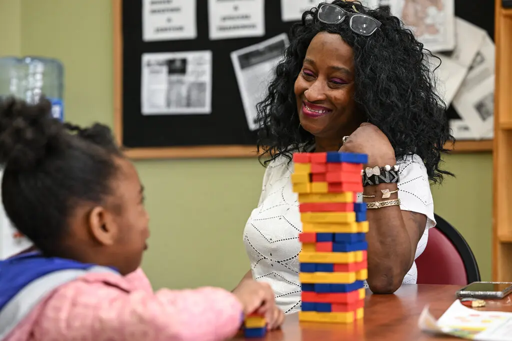 Charlene Williams sits across from her daughter while playing Jenga at the Baltimore addiction center