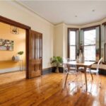 A view of a home with wood floors and a bay window that's holding an open house this weekend.