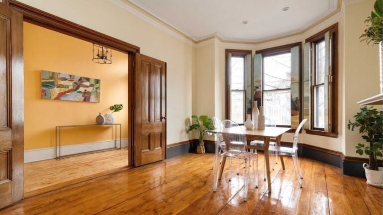 A view of a home with wood floors and a bay window that's holding an open house this weekend.