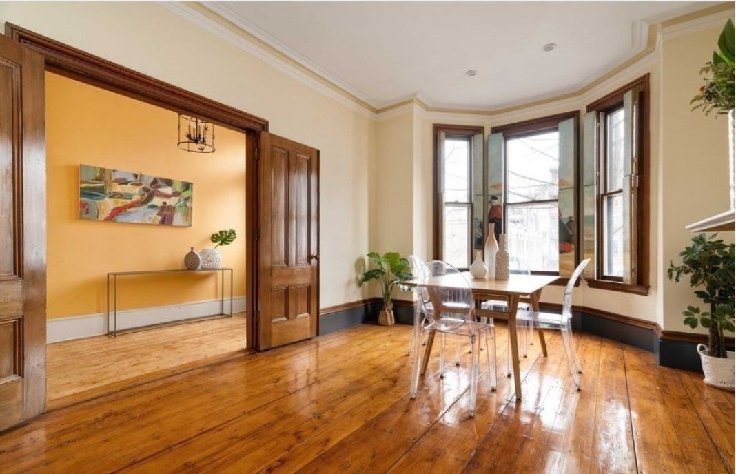 A view of a home with wood floors and a bay window that's holding an open house this weekend.
