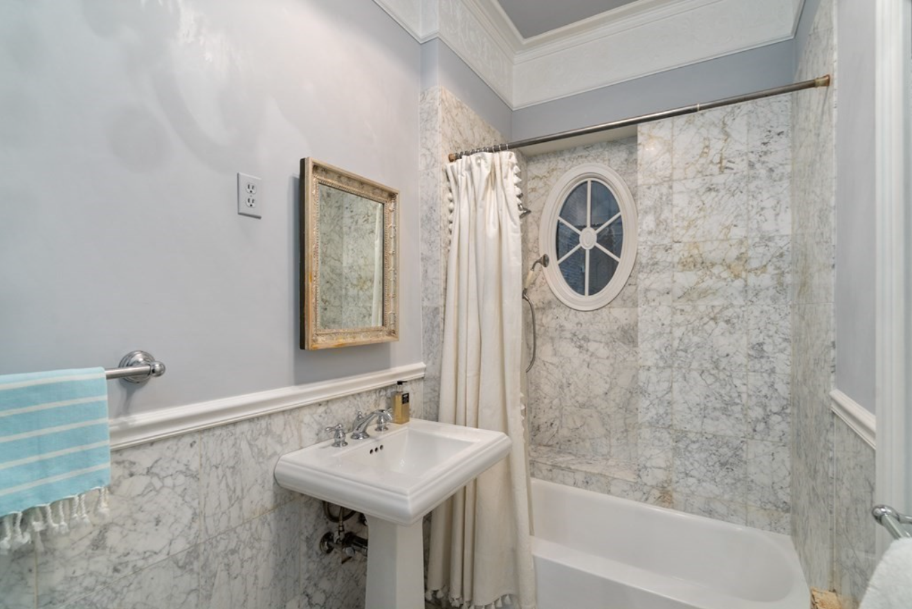 The bathroom has a combination shower-tub and a single vanity.