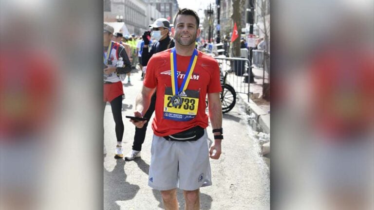 alt = Jeff Kirchick, wearing a red shirt and running shorts, after running a Boston Marathon in a previous year.