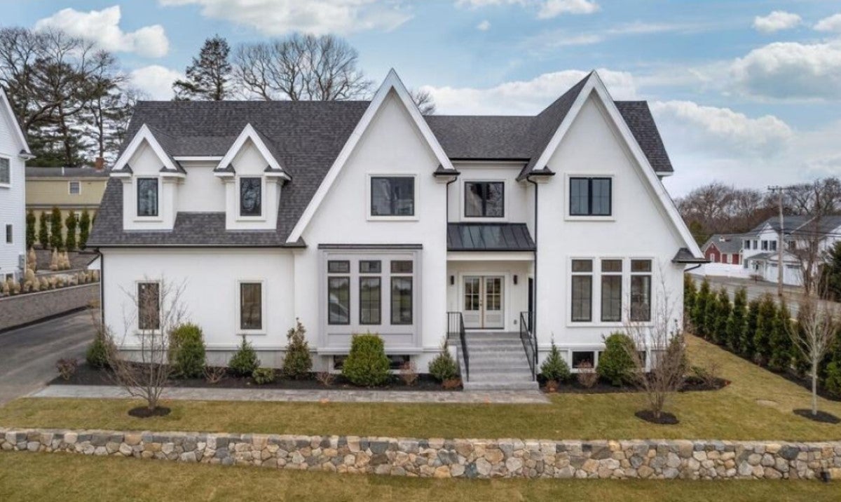 A white single-family home with no shutters, a dormer, and sharp roof lines is used as an example of open houses being held this weekend.