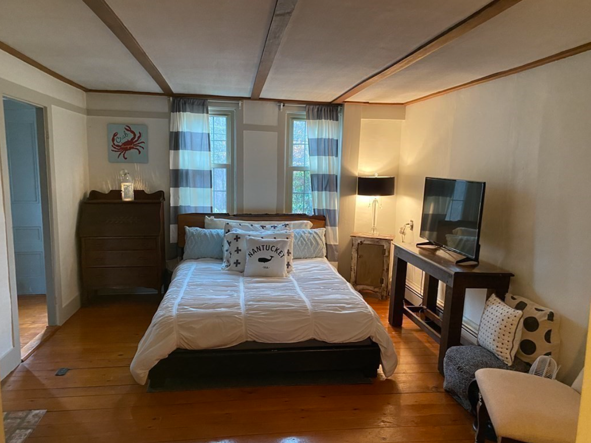 The bedrooms have hardwood floors and exposed wood ceiling beams.