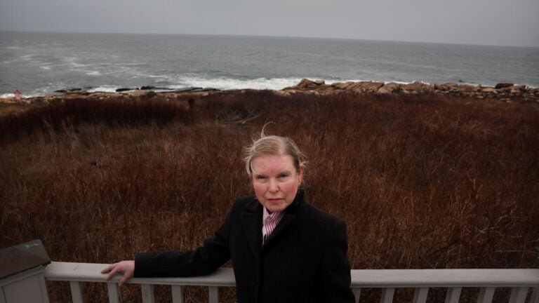 Elizabeth Fisher outside her home at Andrew's Point in Rockport.