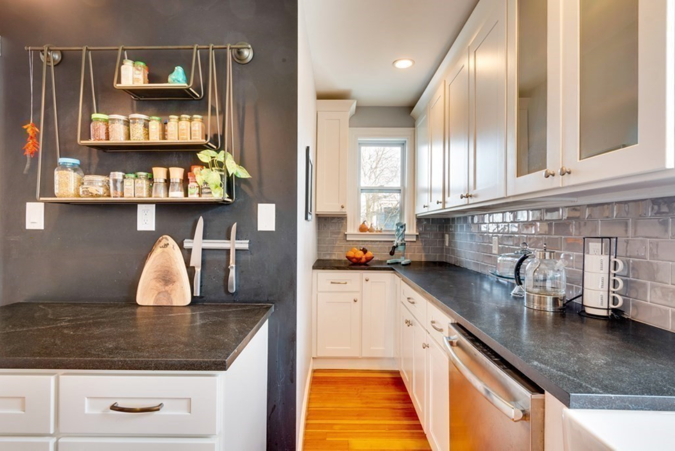 Single-hung windows, white cabinetry and open space keeps the kitchen bright.