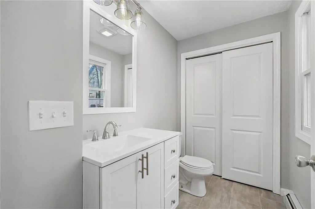 One of the two bathrooms has a single vanity and closet with pocket doors.