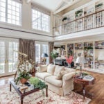 The living room has hardwood floors, vaulted ceilings and picture windows.