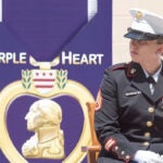 Sarah Jane Cavanaugh posed as a Marine combat veteran with a Purple Heart and Bronze star at a dedication ceremony for the Purple Heart Trail in Rhode Island.