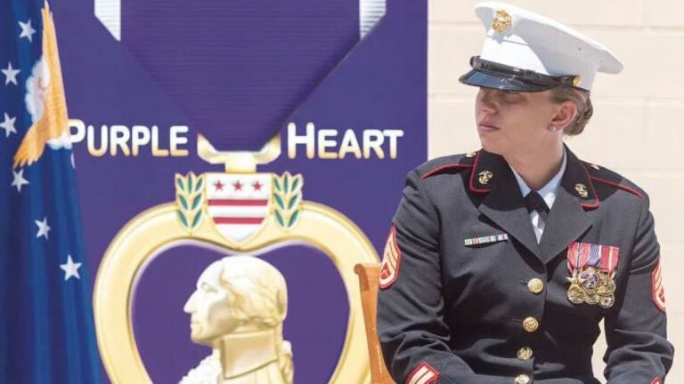 Sarah Jane Cavanaugh posed as a Marine combat veteran with a Purple Heart and Bronze star at a dedication ceremony for the Purple Heart Trail in Rhode Island.