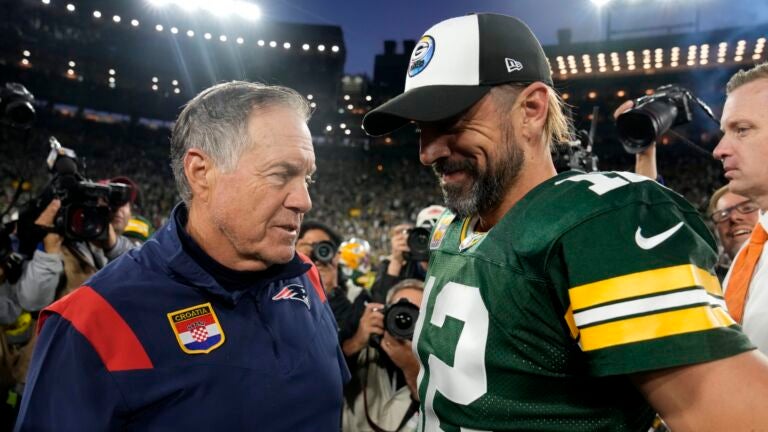 Head coach Bill Belichick of the New England Patriots and Aaron Rodgers #12 of the Green Bay Packers talk after Green Bay's 27-24 win in overtime at Lambeau Field on October 02, 2022 in Green Bay, Wisconsin.