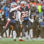 New England Patriots safety Devin McCourty (32) celebrates with cornerback Jonathan Jones (31) after an interception during the first half of an NFL football game against the Cincinnati Bengals, Saturday, Dec. 24, 2022, in Foxborough, Mass.
