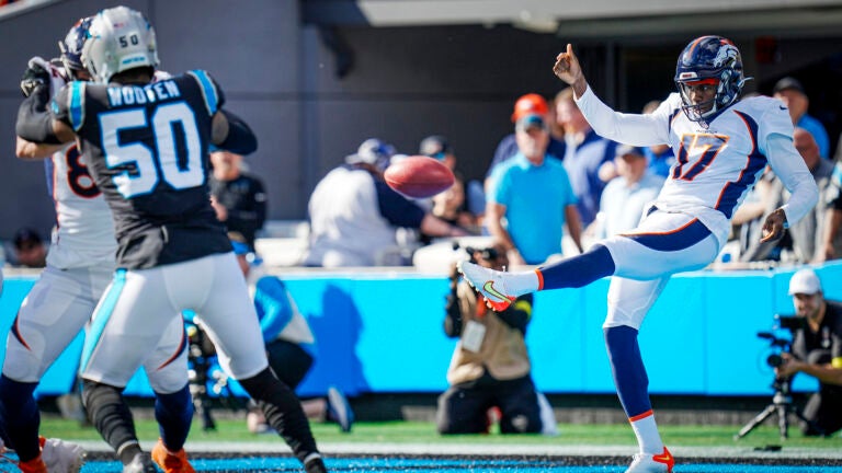 Denver Broncos punter Corliss Waitman (17) punts during an NFL football game against the Carolina Panthers Sunday, Nov. 27, 2022, in Charlotte, N.C.