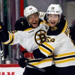 The Bruins David Pastrnak celebrates after his goal with teammate Tyler Bertuzzi.