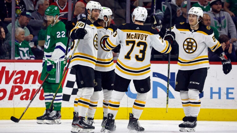 Boston Bruins Pavel Zacha, Charlie McAvoy (73) and Tyler Bertuzzi celebrate a goal with David Pastrnak