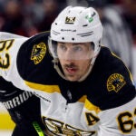 Boston Bruins' Brad Marchand (63) waits for a face-off against the Carolina Hurricanes during the third period of an NHL hockey game in Raleigh, N.C., Sunday, Jan. 29, 2023.