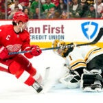 Red Wings center Dylan Larkin shoots on Bruins goaltender Jeremy Swayman