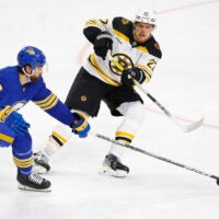 Boston Bruins defenseman Hampus Lindholm passes the puck